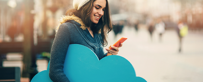 woman holding cellphone and blue cloud