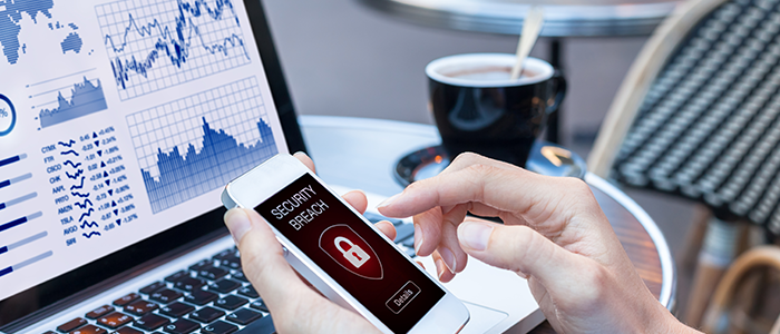 Woman holding phone with cybersecurity breach